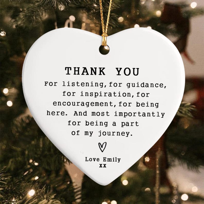 White heart-shaped ornament with gold string, featuring the text "THANK YOU" and a heartfelt message. Includes a small heart symbol and the name "Emily". A thoughtful gift for appreciation.