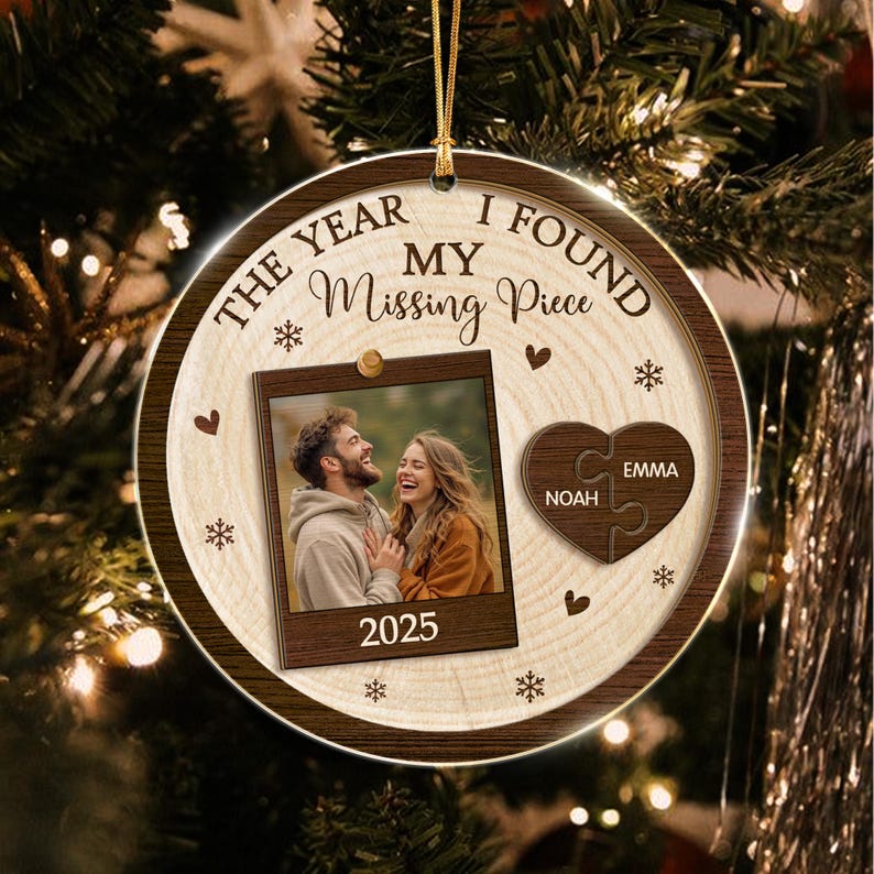 A round, wood-grain patterned Christmas ornament featuring the text THE YEAR I FOUND MY Missing Piece and 2025.
