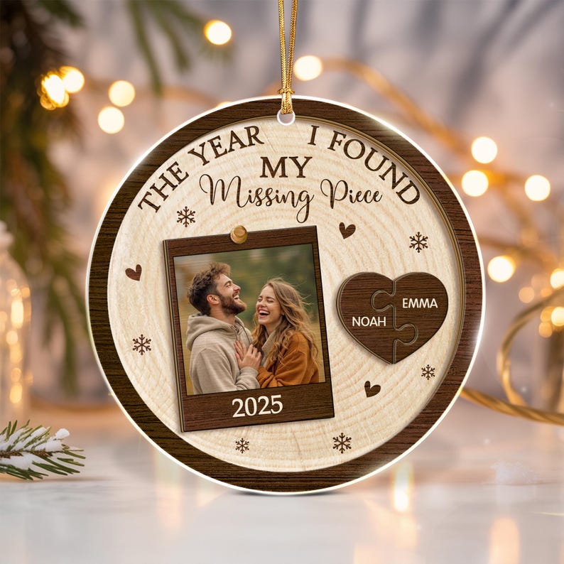 A round, wood-grain patterned Christmas ornament featuring the text THE YEAR I FOUND MY Missing Piece and 2025.