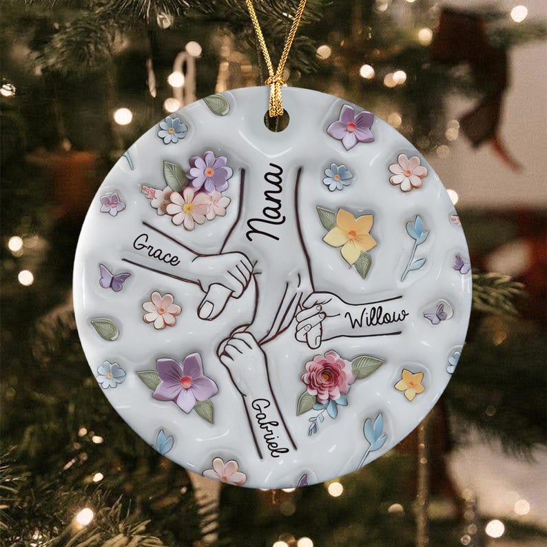 A round white ceramic ornament featuring a central illustration of four hands holding each other. The names Nana, Grace, Willow, and Gabriel are printed on the arms.