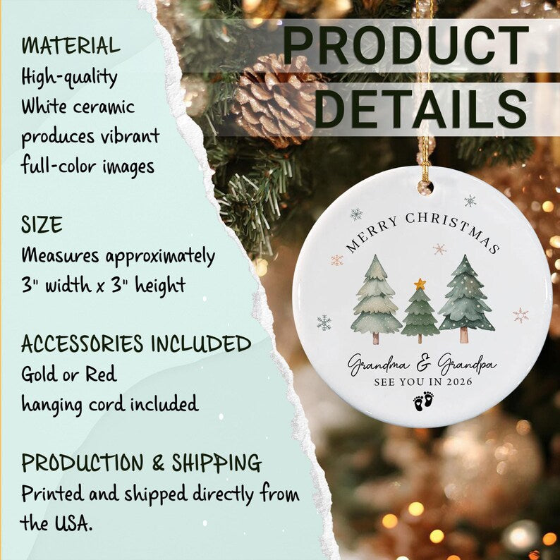 A round white ceramic ornament featuring a printed design of three pine trees, the text MERRY CHRISTMAS, Grandma & Grandpa, SEE YOU IN 2026, and small baby footprints.