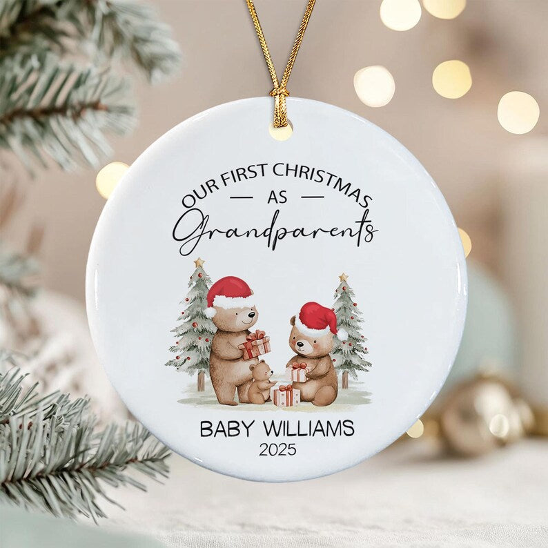 A round white ceramic Christmas ornament featuring a gold hanging string.
