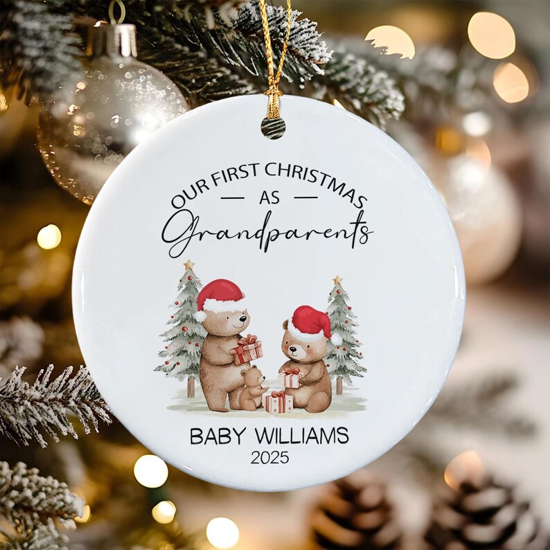 A round white ceramic ornament featuring the text "OUR FIRST CHRISTMAS AS Grandparents" above an illustration of three brown bears wearing red Santa hats, with the text "BABY WILLIAMS" and "2025" printed at the bottom.