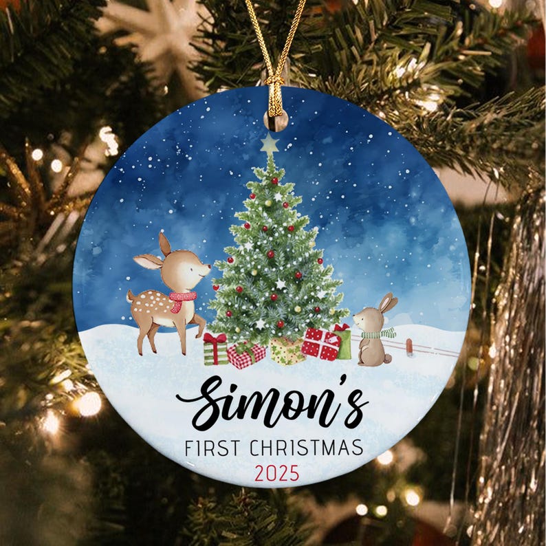 A round ceramic Christmas ornament featuring a watercolor illustration of a deer and a rabbit near a decorated tree with gifts.