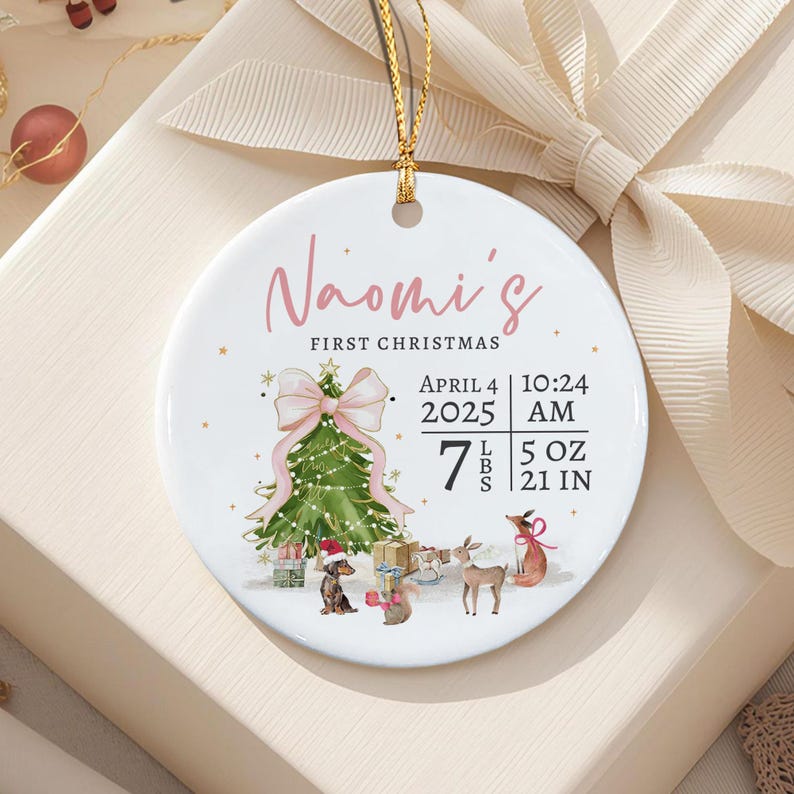 A round white ceramic ornament with a gold hanging string.