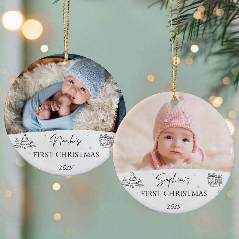 Two round Christmas ornaments with gold hanging strings. One features a baby in a blue hat and blanket, the text reads "Noah's First Christmas 2025".