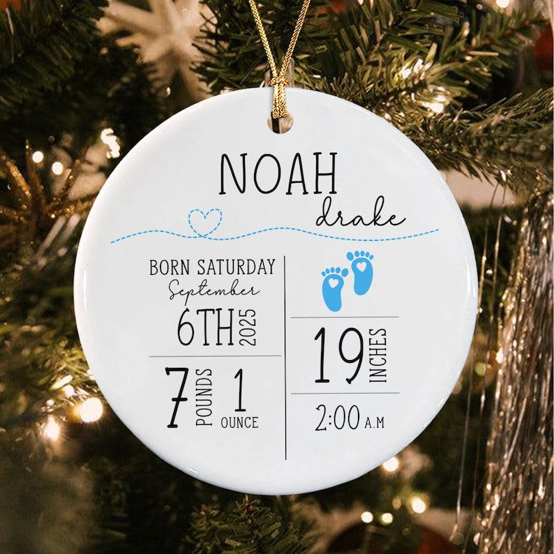 A round white ceramic ornament featuring the name Noah Drake, birth details including Saturday September 6th 2025, 7 pounds 1 ounce, 19 inches, and 2:00 A.M.