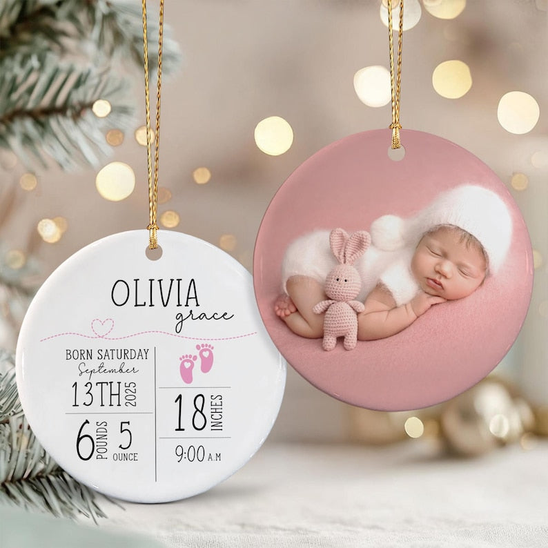 Two round ceramic ornaments with gold hanging strings. One white ornament features the text OLIVIA grace, birth details including 13th September 2025, 6 pounds 5 ounces, 18 inches, and 9:00 A.M.