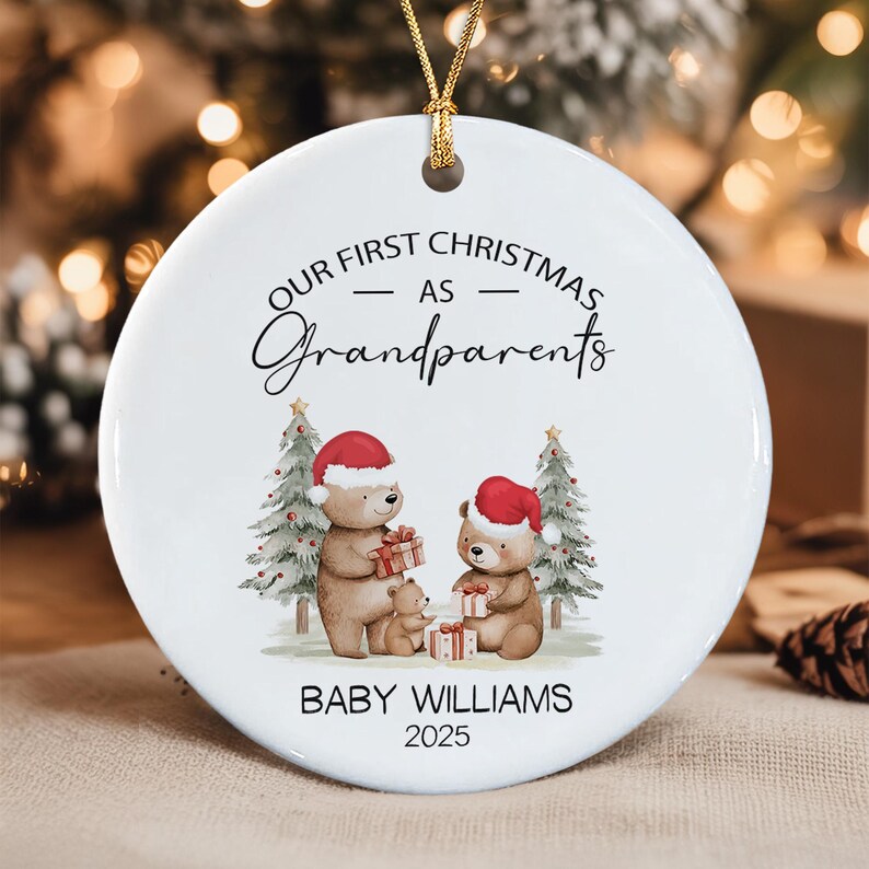 A round white ceramic Christmas ornament featuring a gold hanging string. The text reads OUR FIRST CHRISTMAS AS Grandparents, BABY WILLIAMS, and 2025.
