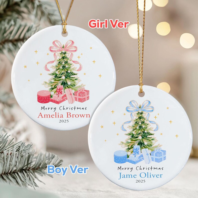 Two round white ceramic ornaments with gold hanging strings. One features a green Christmas tree with a pink bow, pink gifts, and the text Merry Christmas Amelia Brown 2025.