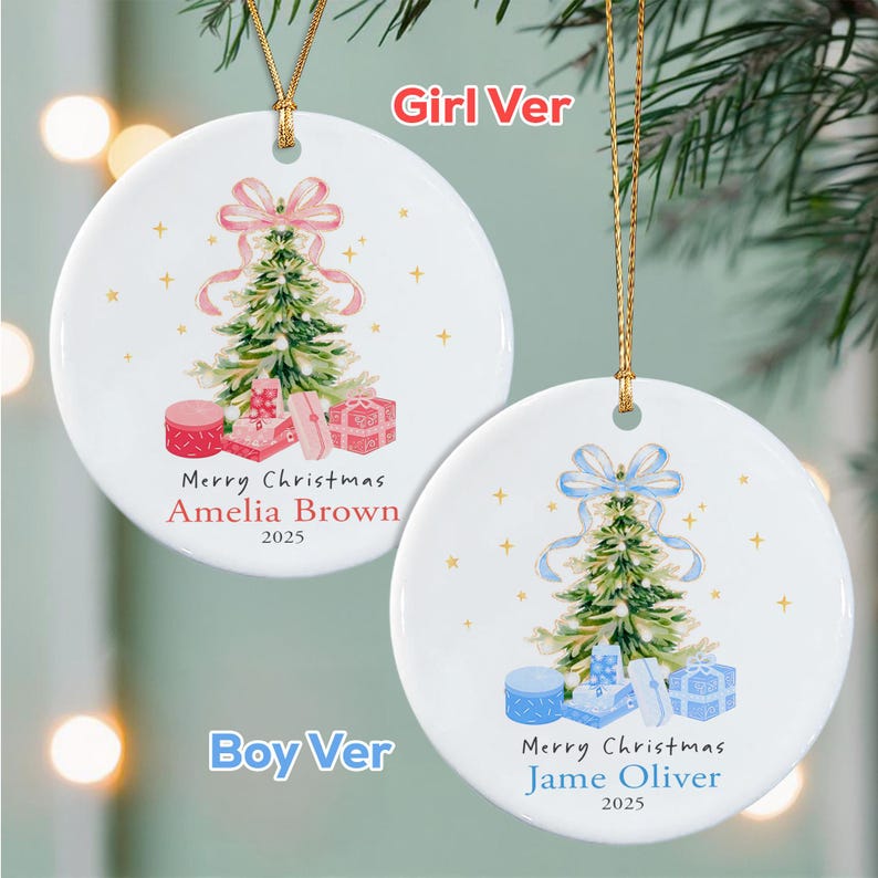 Two round white ceramic ornaments with gold hanging strings. One features a green Christmas tree with a pink bow, pink gifts, and the text Merry Christmas Amelia Brown 2025.