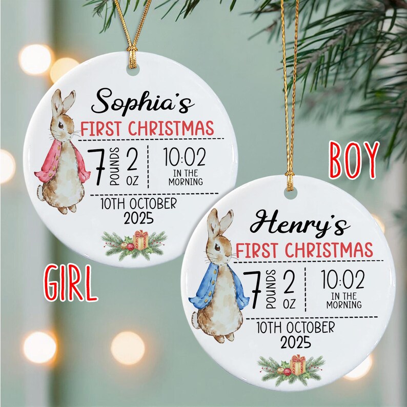 Two round white ceramic ornaments with gold hanging strings. One features a rabbit in a pink jacket, the name Sophia, and birth details: 7 pounds 2 ounces, 10:02 in the morning, 10th October 2025.