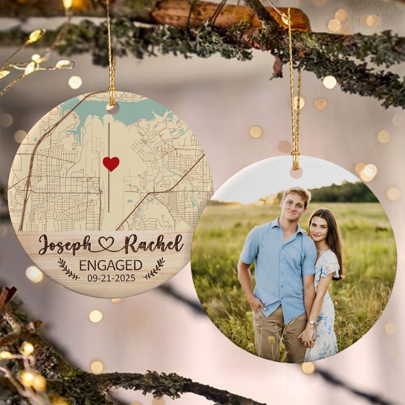 Two round ceramic ornaments hanging from gold strings. One ornament features a beige map with a red heart and the text Joseph & Rachel ENGAGED 09-21-2025.