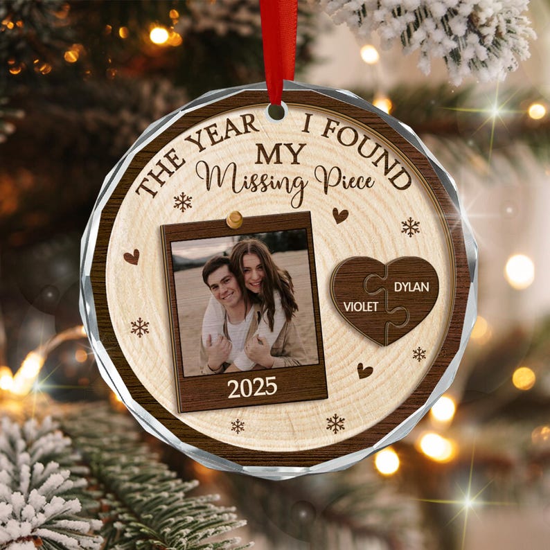 A round, wood-grain patterned Christmas ornament featuring the text THE YEAR I FOUND MY Missing Piece and 2025.