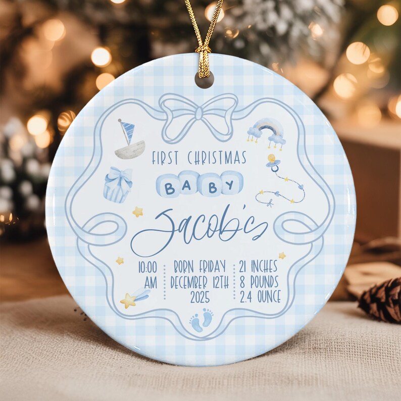 A round ceramic ornament with a light blue gingham pattern, featuring a central bow graphic and the text First Christmas Baby Jacob's.