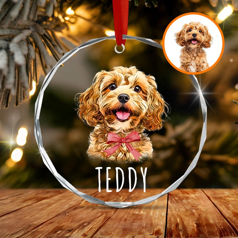 A circular clear acrylic Christmas ornament featuring a colorful illustration of a golden-brown curly-haired dog wearing a red bow tie, with the name TEDDY printed in white below.