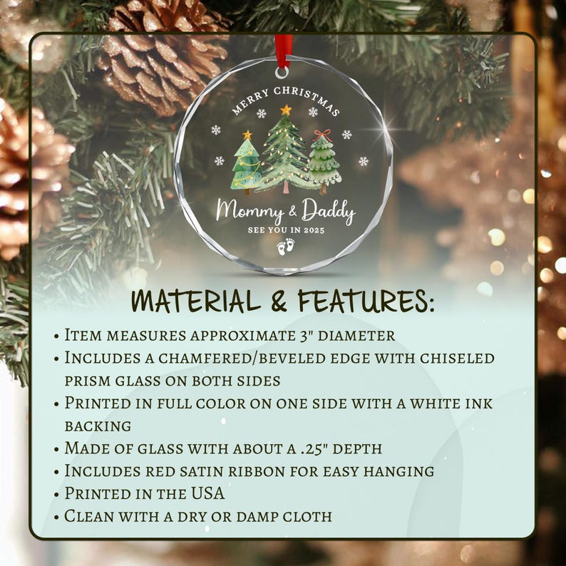 A clear glass Christmas ornament with a red ribbon for hanging. The ornament features the text "Merry Christmas" and "Mommy & Daddy" with a design of Christmas trees and snowflakes.
