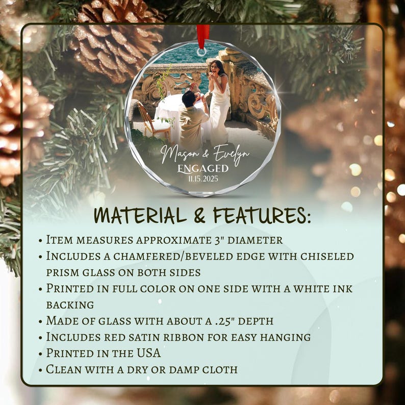 A circular glass ornament with a beveled edge and red satin ribbon. The front features a photograph of a couple at a table with the text Mason & Evelyn ENGAGED 11.15.2025. It measures 3 inches in diameter and 0.25 inches in depth.