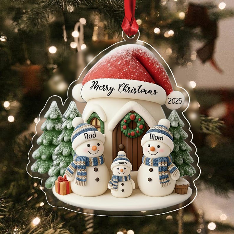 A flat Christmas tree ornament featuring a house with a red Santa hat roof, labeled Merry Christmas and 2025.