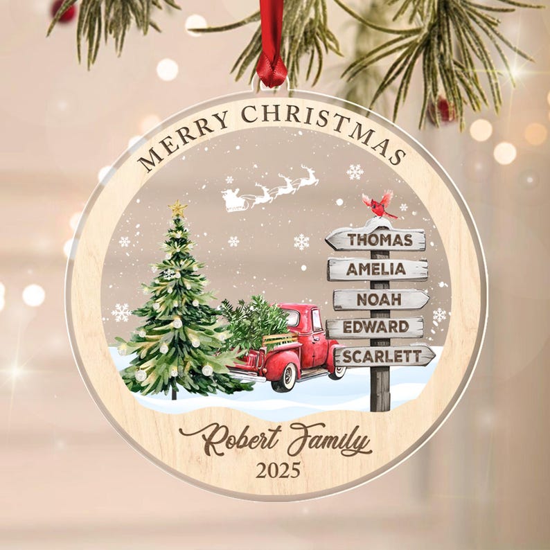 A round, clear acrylic Christmas ornament with a wooden border and red ribbon.