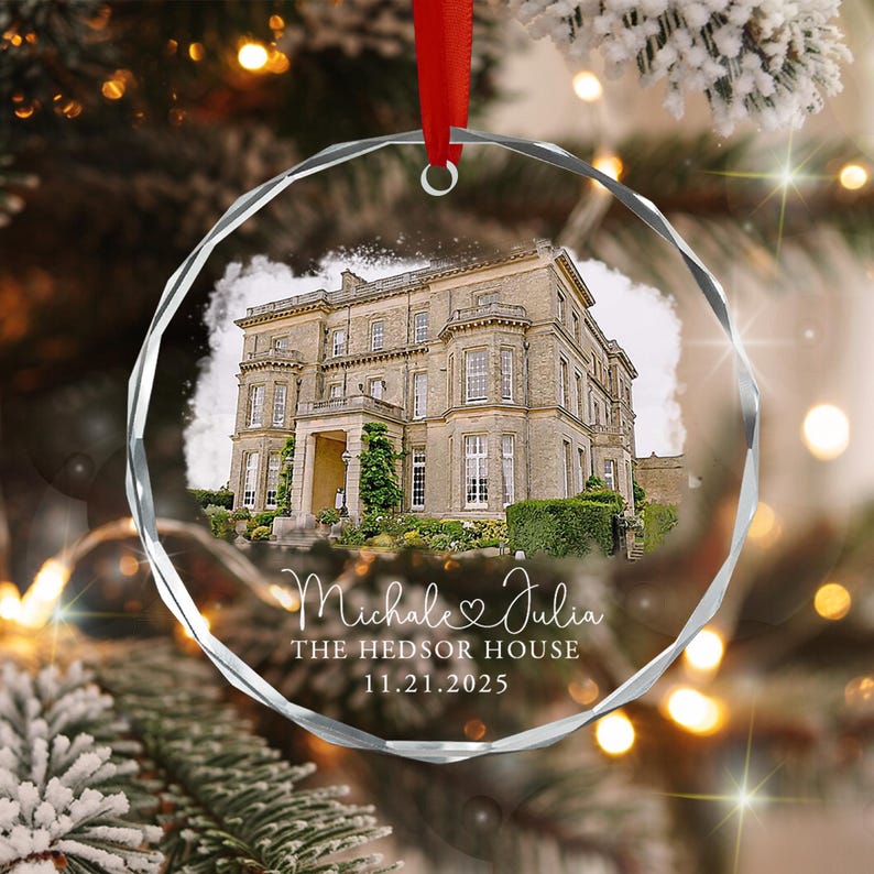A circular, faceted glass ornament featuring a printed image of a large stone manor house. Below the house, white text reads "Michale & Julia", "THE HEDSOR HOUSE", and the date "11.21.2025".