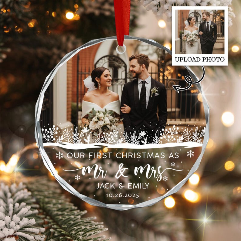 A circular, faceted glass Christmas ornament featuring a printed photograph of a couple in wedding attire.