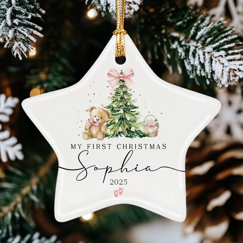 A white star-shaped ceramic ornament featuring a watercolor illustration of a teddy bear, a Christmas tree with a pink bow, and a basket.