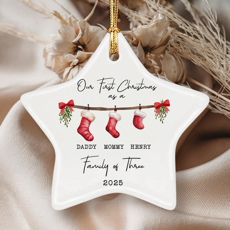 A white star-shaped ceramic ornament with a gold hanging cord.