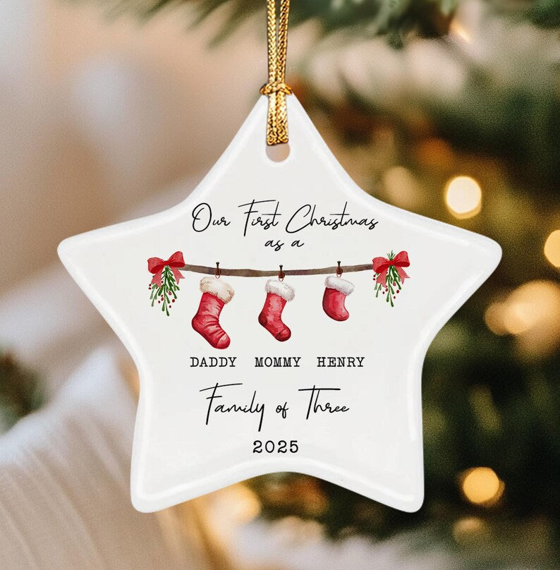A white star-shaped ceramic ornament hanging by a gold cord.
