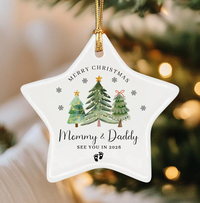 A white star-shaped ceramic Christmas ornament with a gold hanging cord.