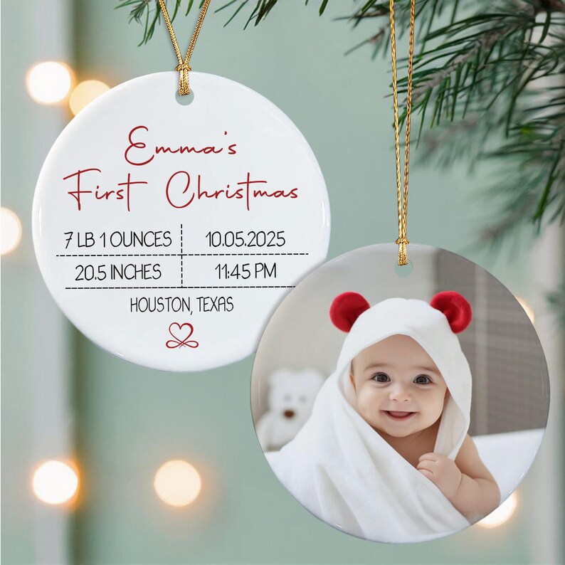 A round white ceramic ornament featuring the red text Emma's First Christmas, birth details including 7 LB 1 OUNCES, 20.5 INCHES, 10.05.2025, 11:45 PM, and HOUSTON, TEXAS.