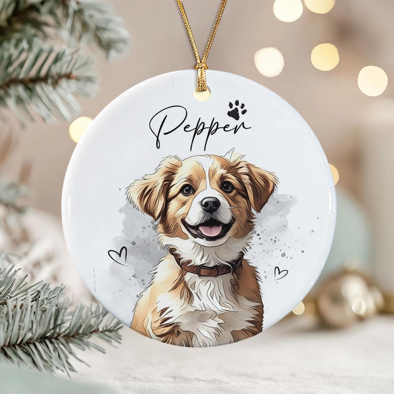 A round white ceramic ornament featuring a watercolor-style illustration of a brown and white dog with a collar.