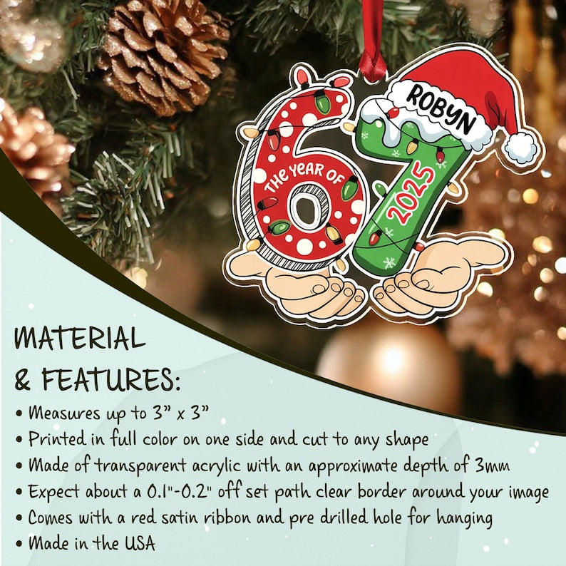 A custom Christmas ornament shaped like the number 67, featuring a red polka-dot 6 and a green 7 with a Santa hat. The text reads THE YEAR OF, ROBYN, and 2025.