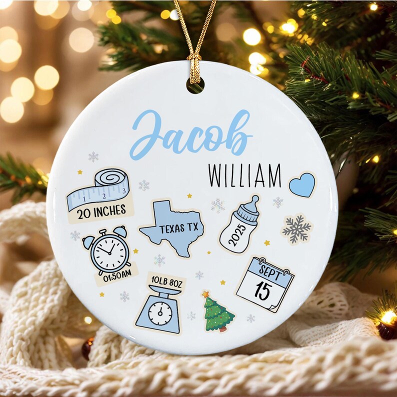 A round white ceramic ornament with a gold hanging cord.