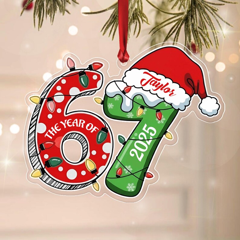 A flat Christmas ornament shaped like the numbers 67, featuring a red polka-dot 6 with the text THE YEAR OF and a green 7 with the text 2025.