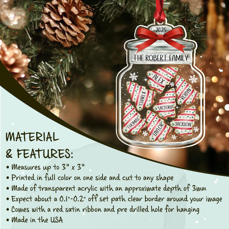 A transparent acrylic Christmas ornament shaped like a jar filled with seven tree-shaped cookies, each personalized with a name. The jar features a red ribbon bow, the text THE ROBERT FAMILY, and the year 2025.