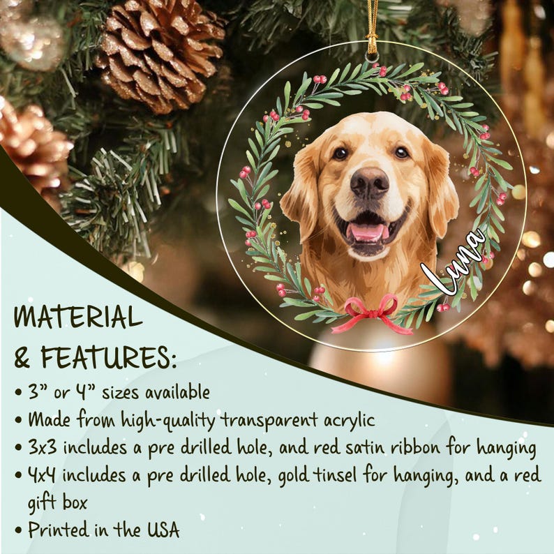 A circular transparent acrylic ornament featuring a golden retriever portrait framed by a green leafy wreath with red berries and a red bow at the bottom. The name Luna is written in white script on the right side of the wreath.