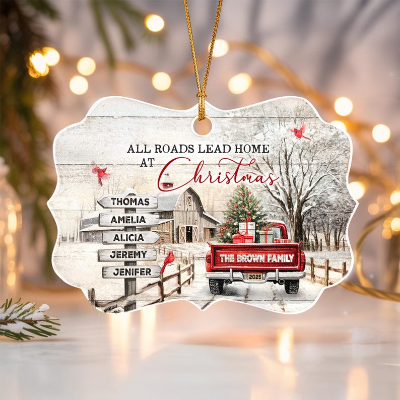 A decorative ornament with a scalloped edge featuring a winter scene with a red truck, a barn, and cardinals.