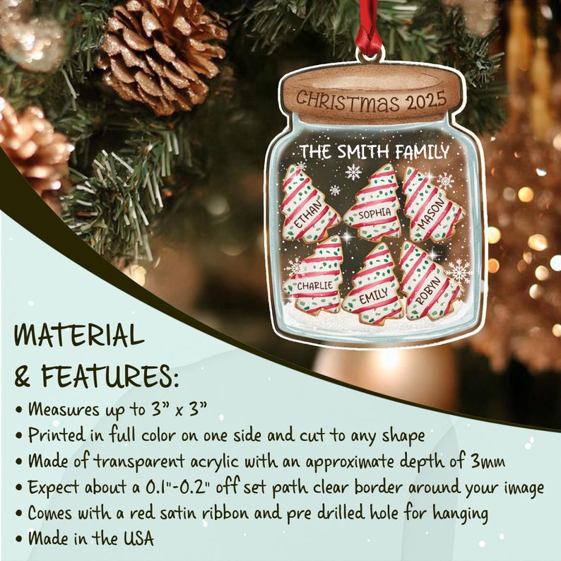A transparent acrylic jar-shaped Christmas ornament featuring a brown lid with the text CHRISTMAS 2025. Inside the jar are six decorated tree-shaped cookies labeled with names.
