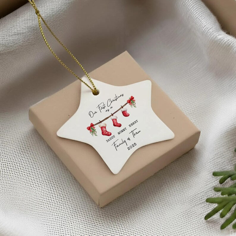 A white star-shaped ceramic ornament with a gold hanging string.