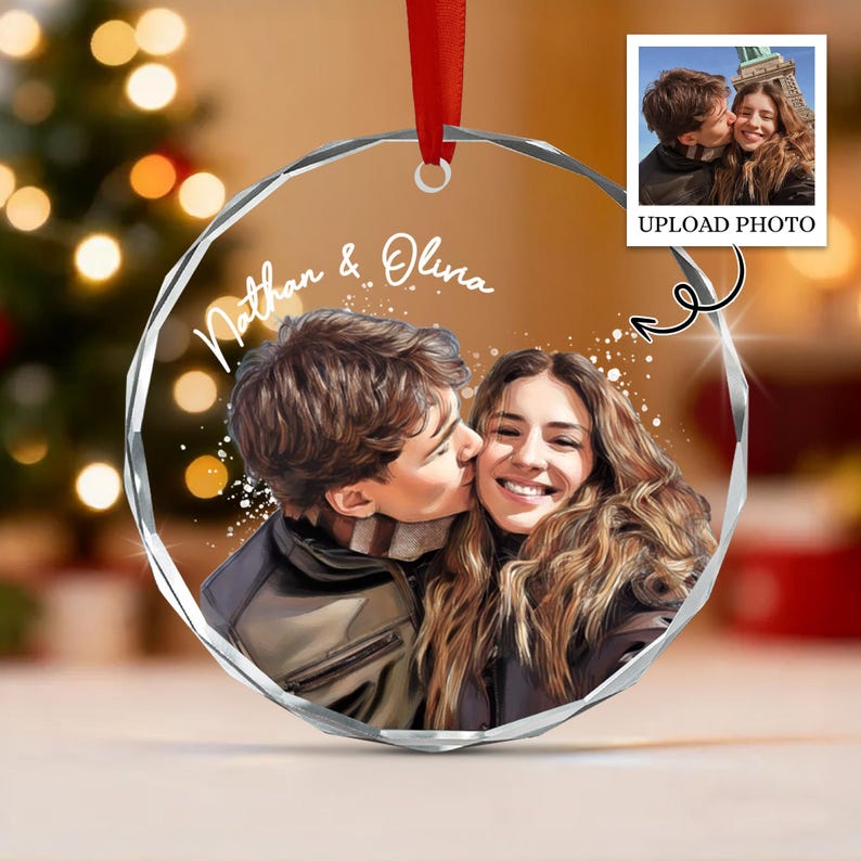 A circular clear acrylic ornament featuring a custom illustration of a couple, with the names Nathan & Olina printed in white script.
