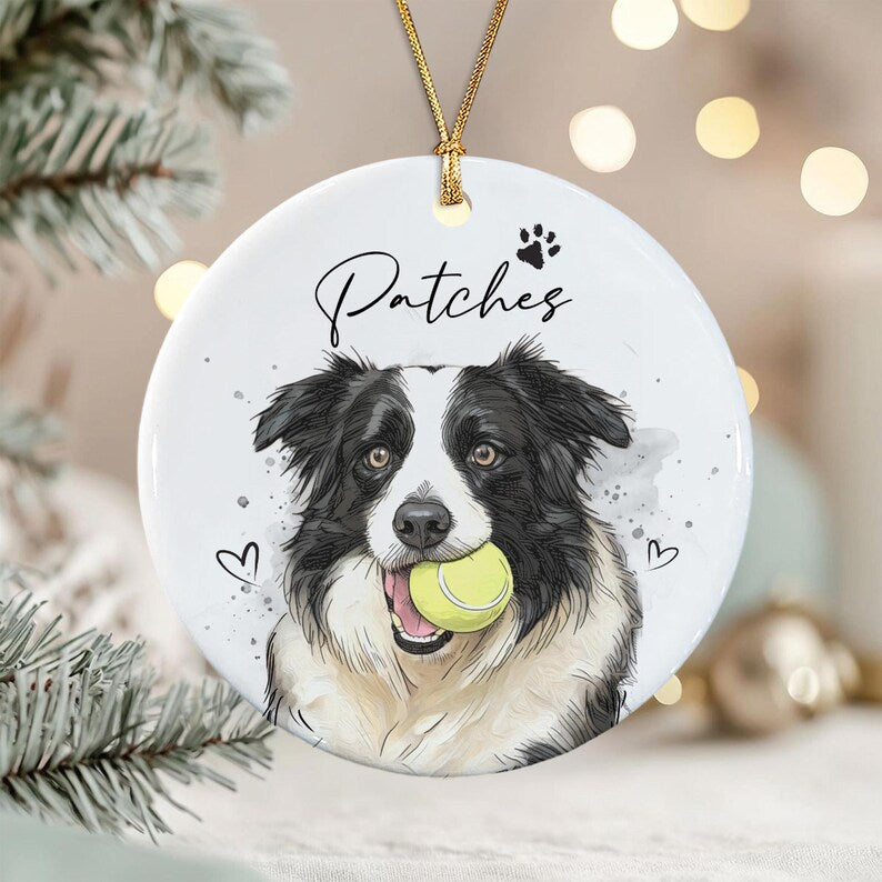 A round white ceramic ornament featuring a black and white Border Collie illustration holding a yellow tennis ball in its mouth.