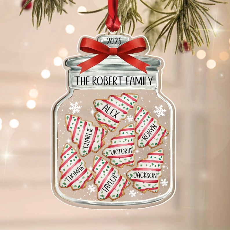 A clear glass jar-shaped Christmas ornament featuring a red ribbon bow at the top with the year 2025.