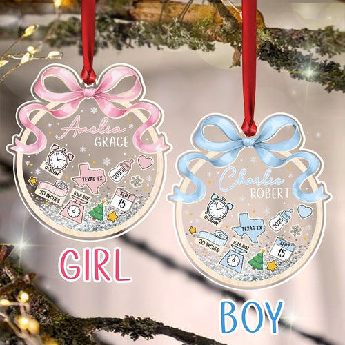 Two personalized baby ornaments, one pink and one blue, with names, birth details, and the words "GIRL" and "BOY." Each ornament has a ribbon for hanging and features a bow, clock, and Texas outline.