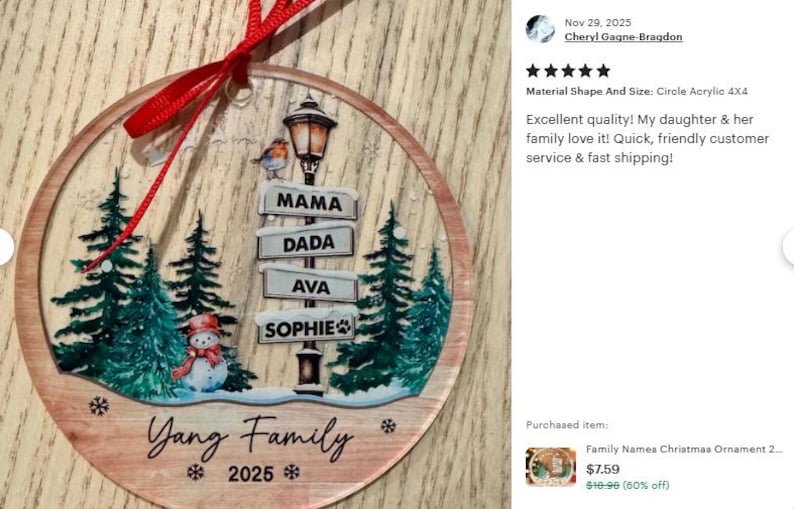A circular clear acrylic Christmas ornament featuring a printed winter scene with green pine trees, a snowman, and a street lamp. The lamp post displays signs reading MAMA, DADA, AVA, and SOPHIE.