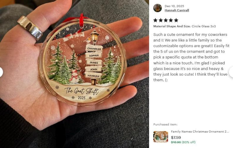 A circular glass Christmas ornament featuring a winter scene with green pine trees, a snowman, and a street sign post displaying the names Chandler, Sophia, James, John, and Hannah.