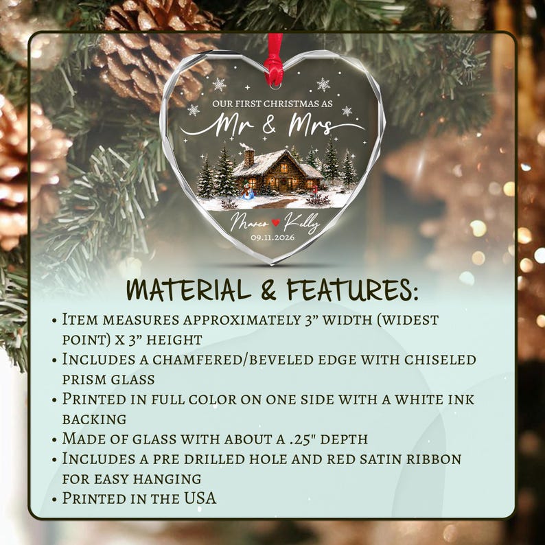 A heart-shaped glass ornament with a beveled edge, measuring 3 inches wide by 3 inches high and 0.25 inches deep. It features a winter cabin scene, the text 'OUR FIRST CHRISTMAS AS Mr & Mrs', 'Marco & Kelly', and '09.11.2026'.