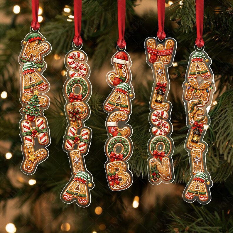 Five vertical Christmas ornaments shaped like gingerbread cookies, each featuring a name spelled out in cookie letters: KATHY, SOPHIA, JACOB, WILSON, and AMELIA.