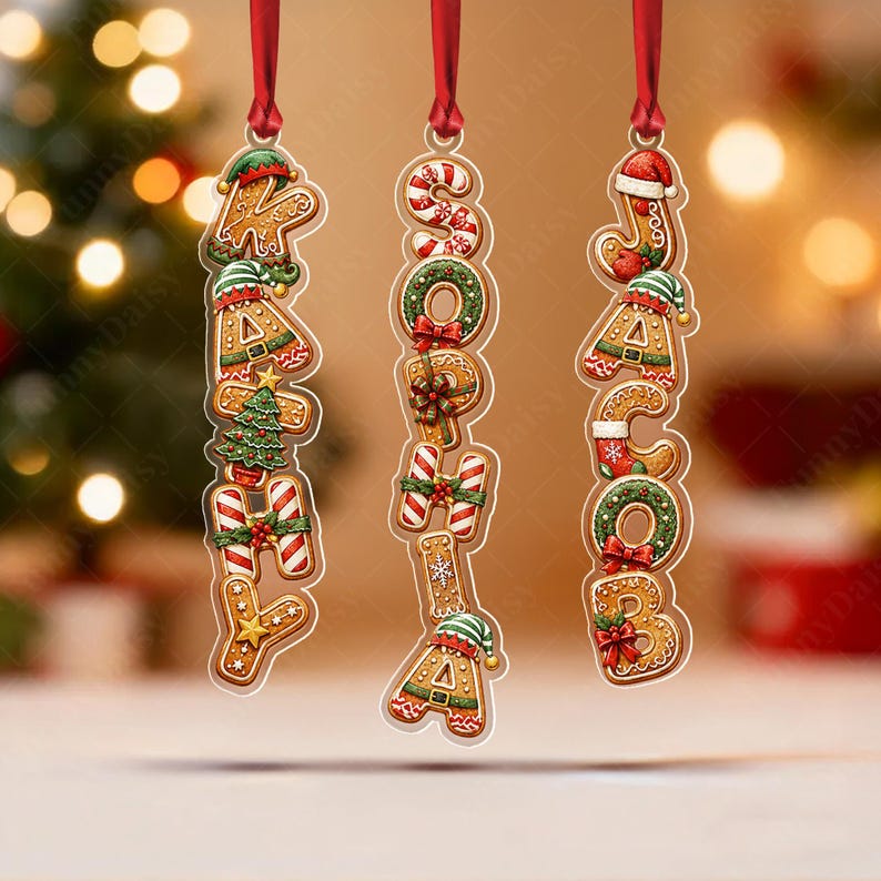 Three vertical hanging ornaments featuring gingerbread-style letters spelling the names KATHY, SOPHIA, and JACOB.