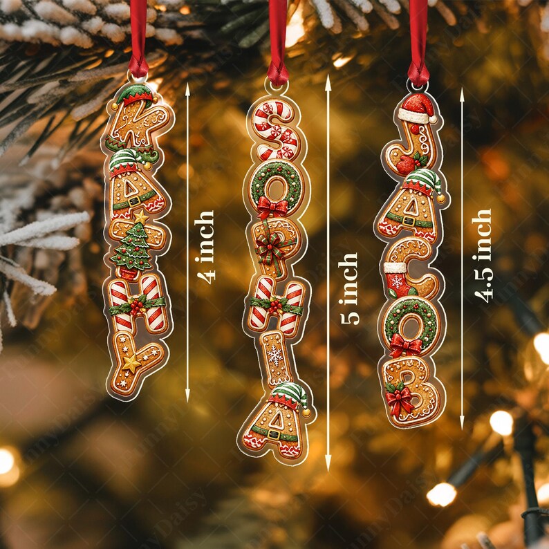 Three vertical Christmas ornaments featuring gingerbread-style letters spelling KATHY, SOPHIA, and JACOB. Each ornament hangs from a red ribbon and displays dimensions of 4 inches, 5 inches, and 4.5 inches respectively.